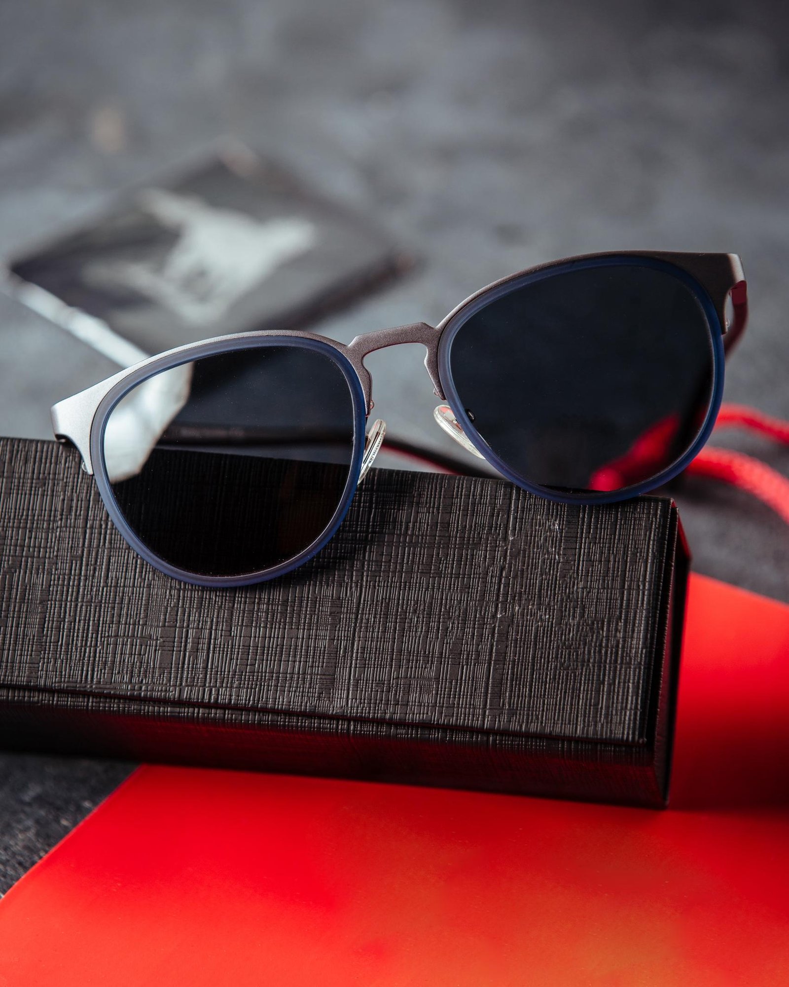 designed-sunglasses-red-book-grey-surface