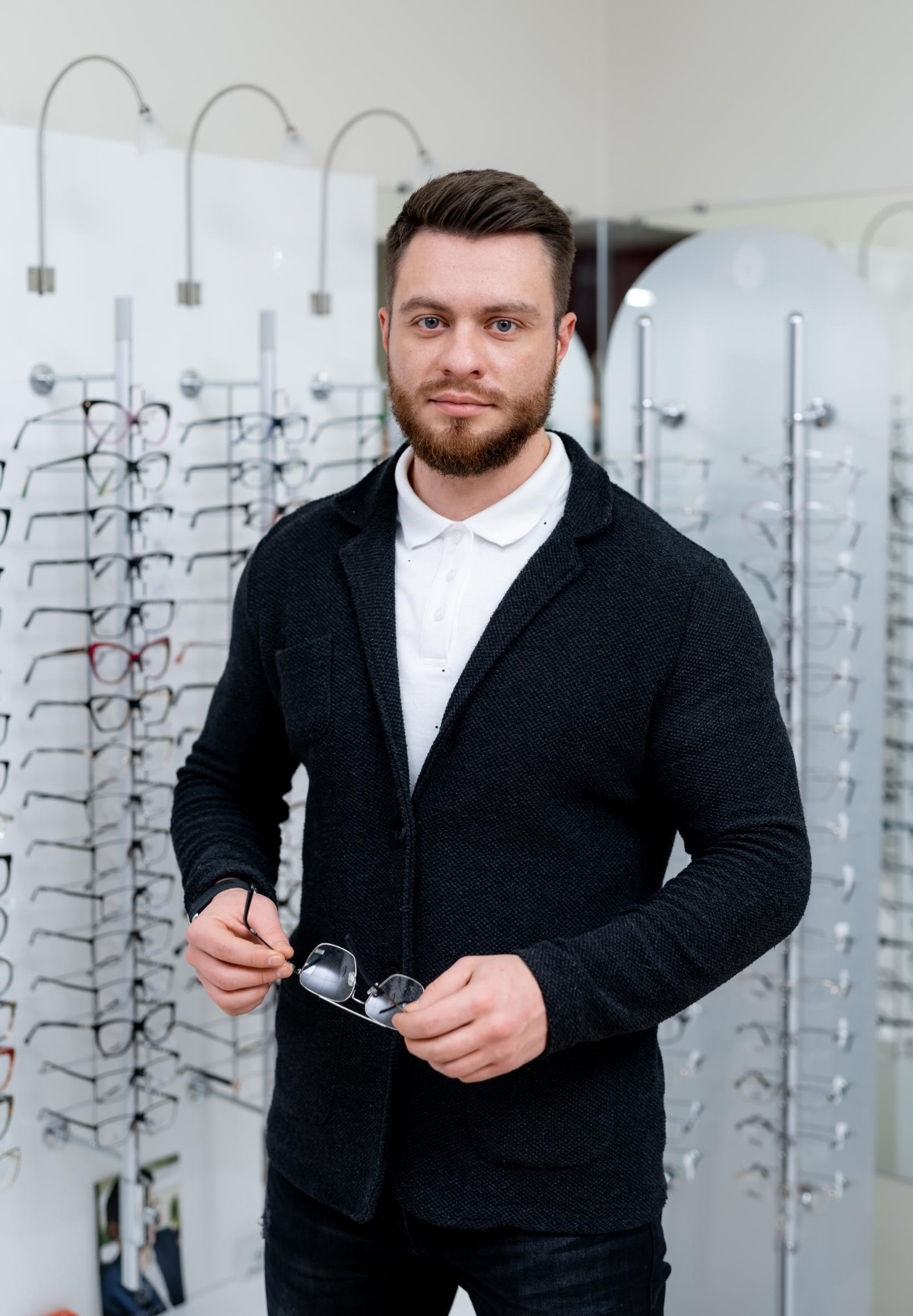 male-client-is-standing-with-set-glasses-background-optical-shop-man-tries-spectacles-eyesight-correction-portrait-man-with-glasses-closeup