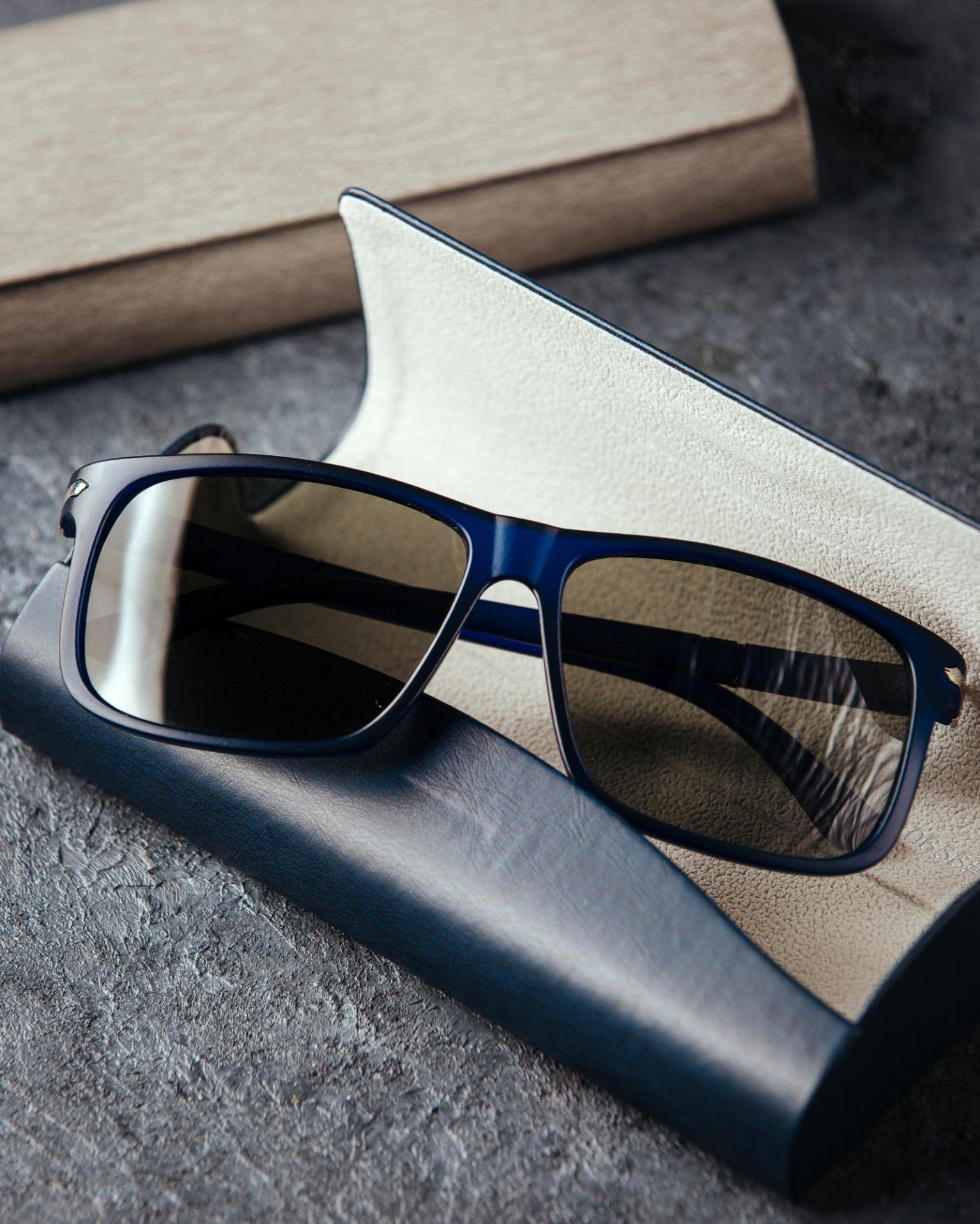 top-view-modern-blue-sunglasses-grey-background-isolated-vision-spectacles-elegance